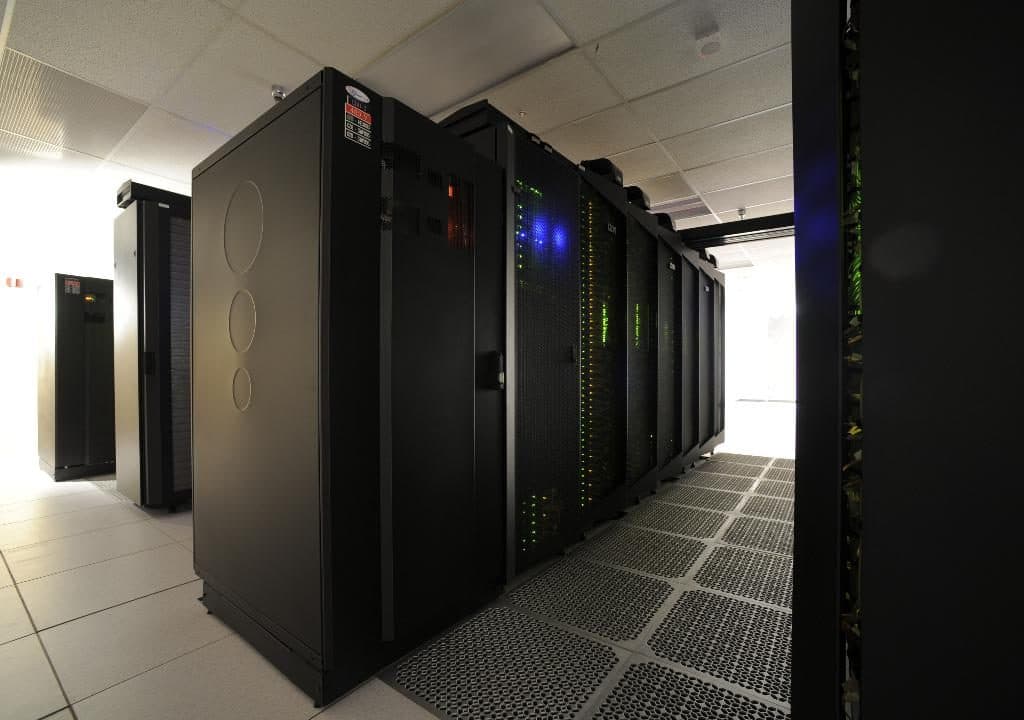 Row of dark server cabinets in a data centre hall