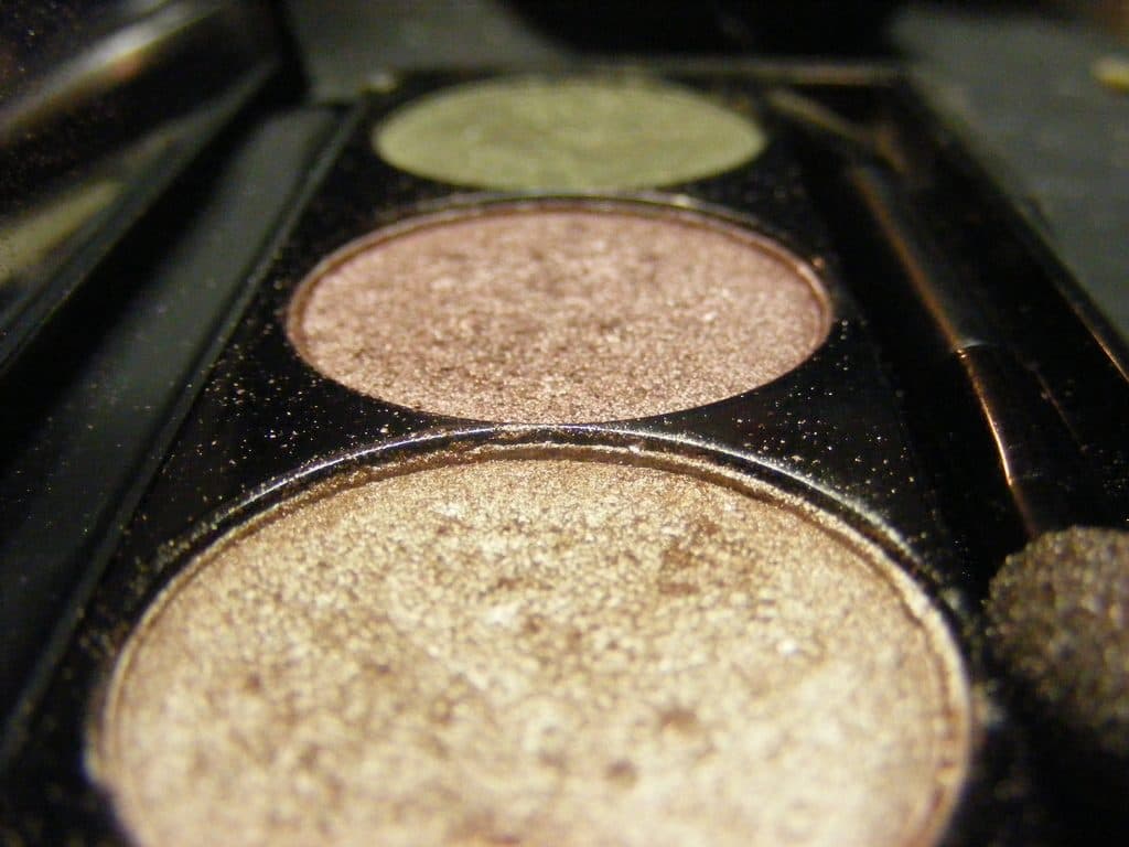 Close-up of shimmering pressed powders in a cosmetics palette