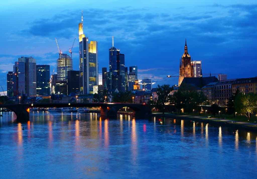 City skyline of office towers at blue hour reflected in the river